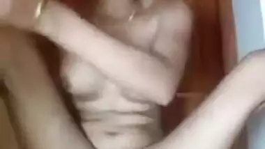 Young Indian woman takes violet pants off spreading XXX legs on the floor