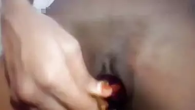 Indian girl plays XXX games on camera shoving an eggplant in her sex hole