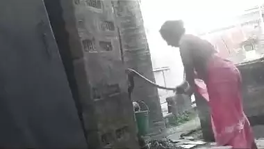 My maid taking shower at backyard