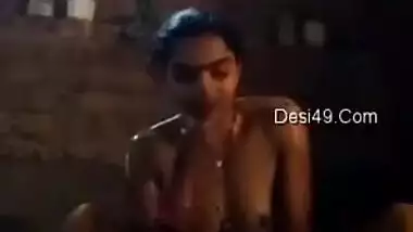 Young Desi woman sets the camera against her and starts washing XXX body