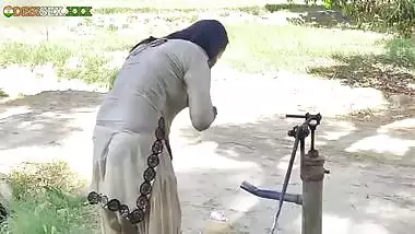 Young village school girl taking a bath in a sari and caught on camera
