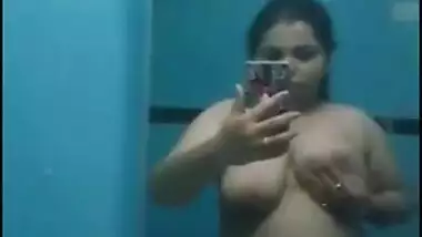 Desi sweet thing touches soft natural breasts in front of a mirror